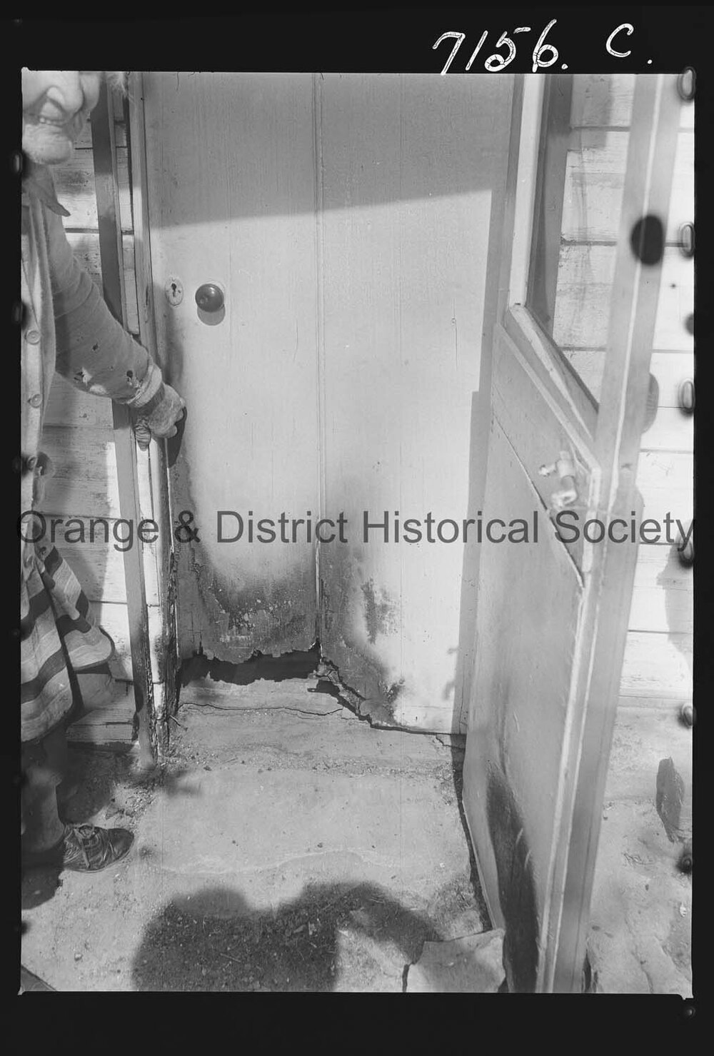Mrs M Walker shows where vandals broke windows and lit fires at her home