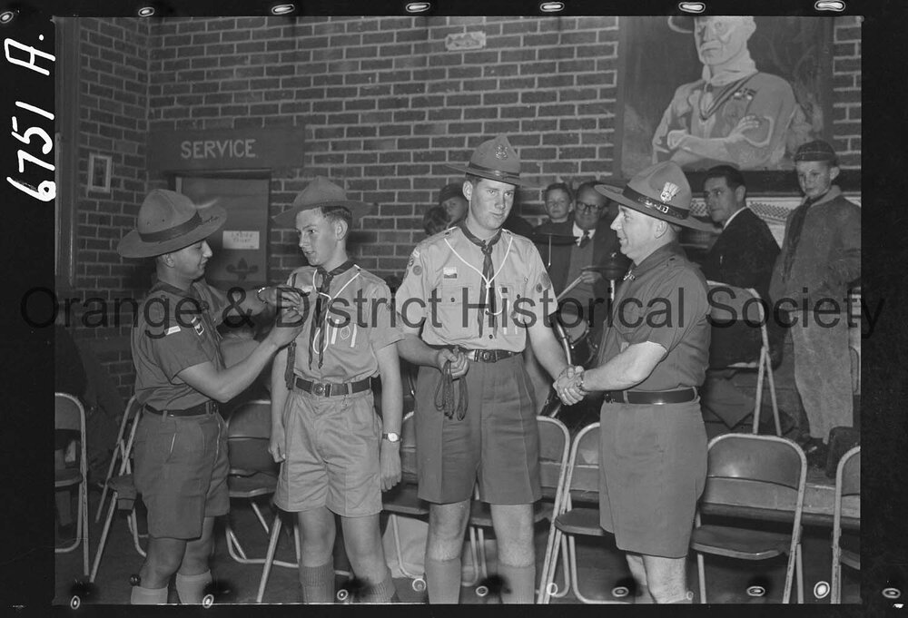 Orange boy scouts awarded with Scout Cords