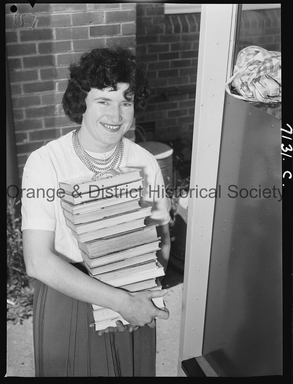 Librarian Joan Barry stacks books in new book mobile