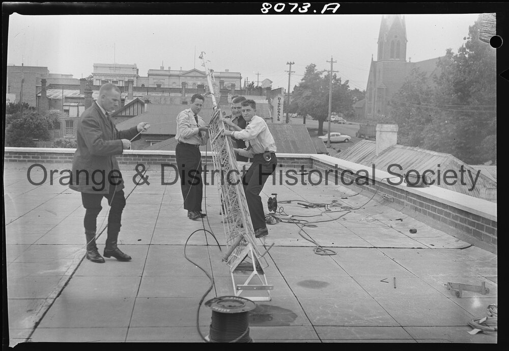 Police erecting the aerial for two-way radio for patrol cars and Police Station
