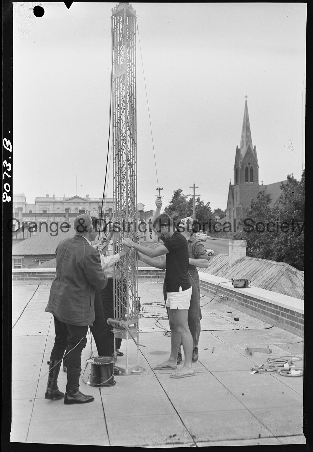 Police erecting the aerial for two-way radio for patrol cars and Police Station