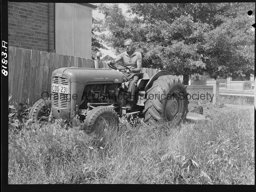 Mr Miller, OCC Works Depot employee cutting long grass in West Orange
