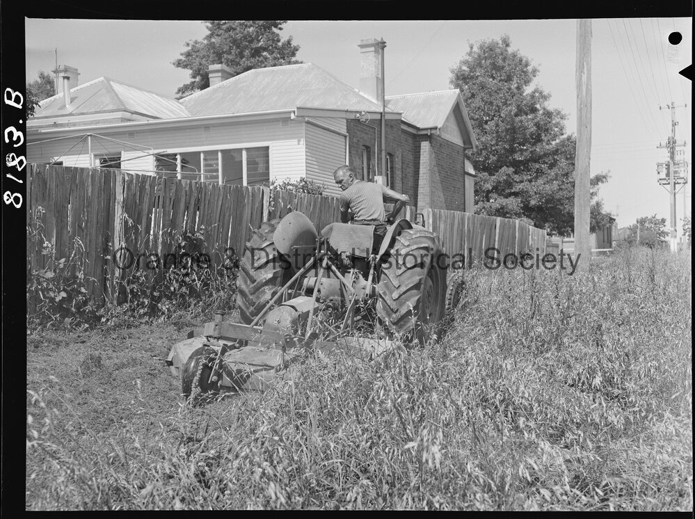 Mr Miller, OCC Works Depot employee cutting long grass in West Orange