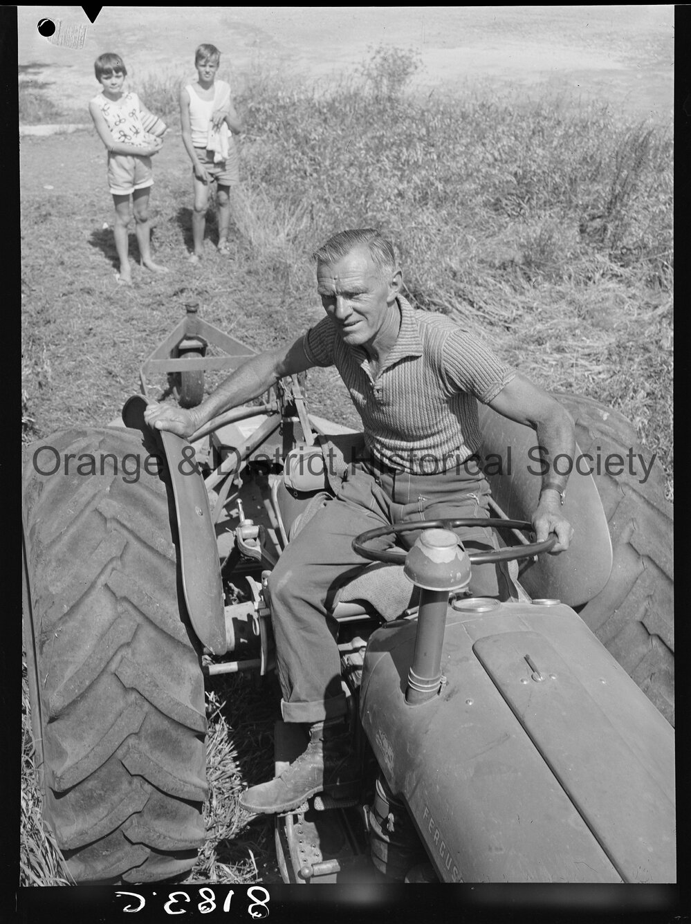 Mr Miller, OCC Works Depot employee cutting long grass in West Orange