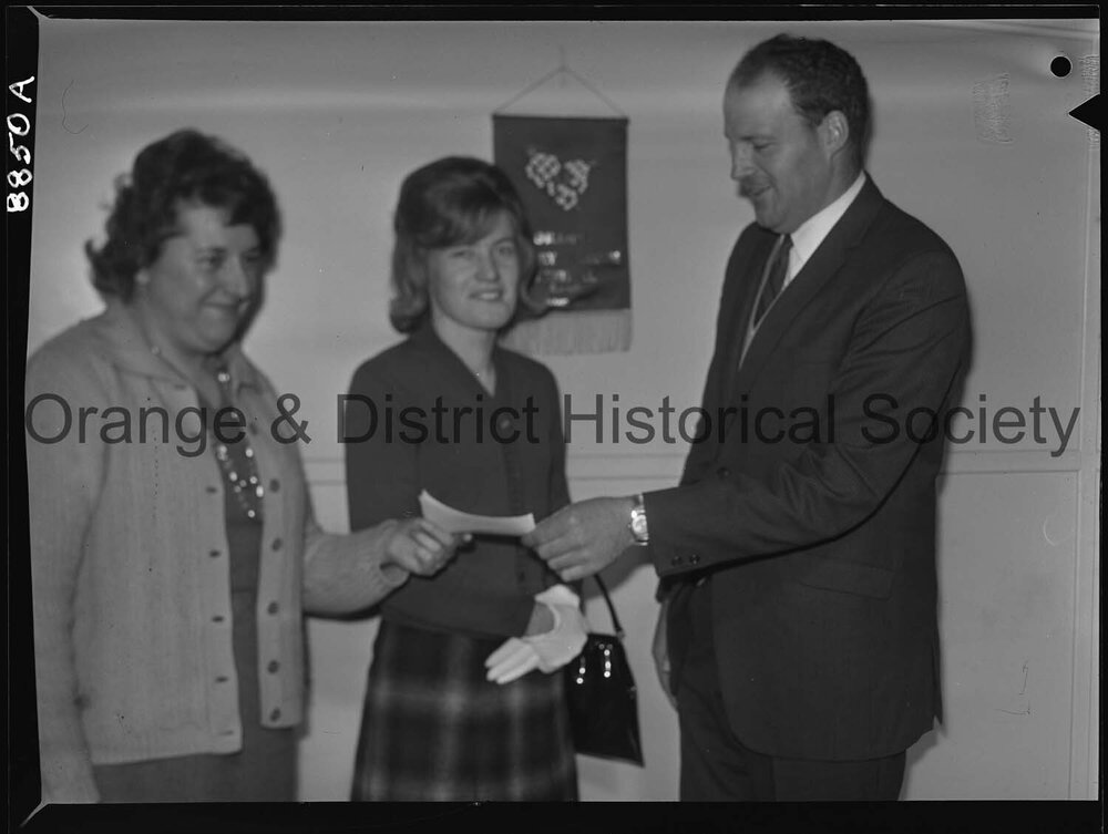 Miss Marcia Hampton hands over cheque