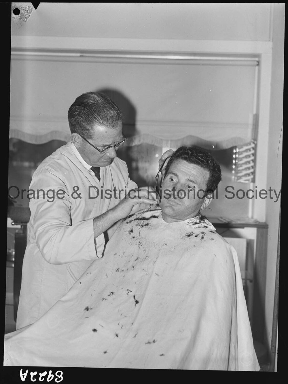 Mr T Stathis has his hair cut by Mr J Baldwin