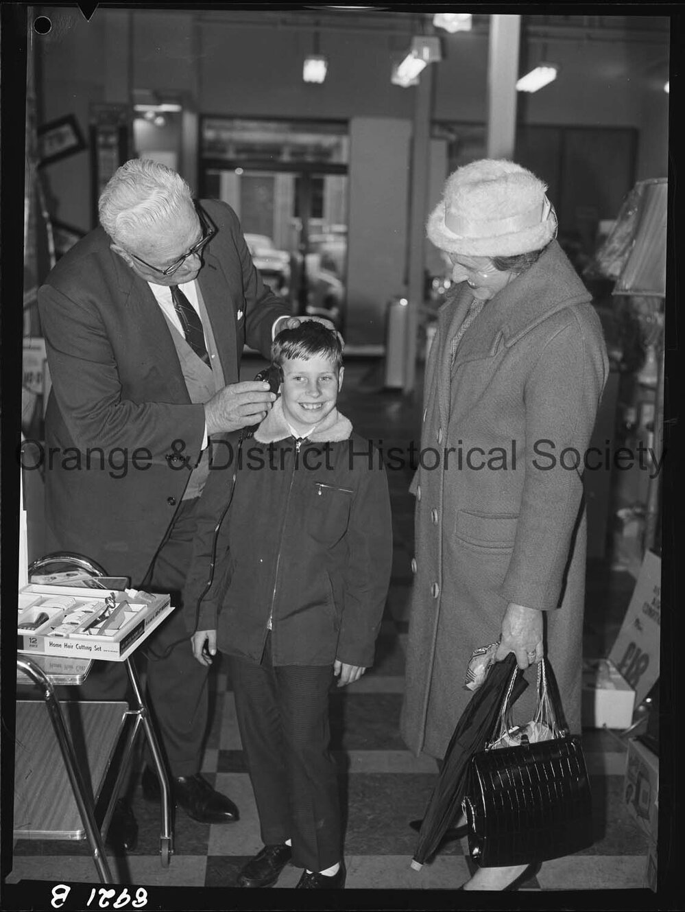 Mr R McDonald demonstrates electric hair clippers at Western Stores