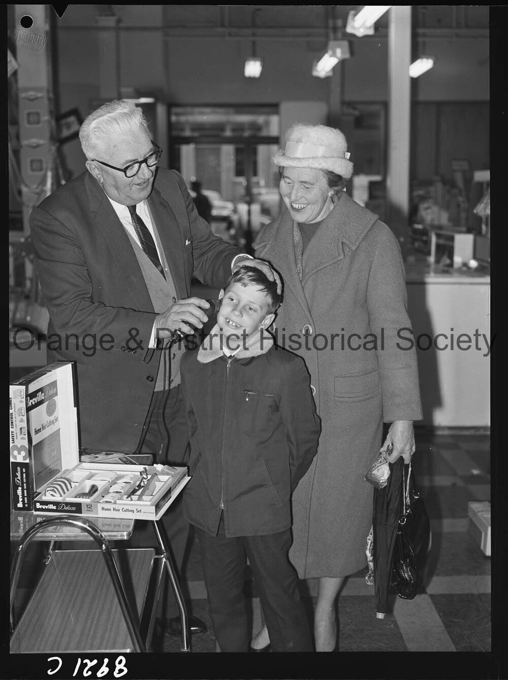 Mr R McDonald demonstrates electric hair clippers at Western Stores