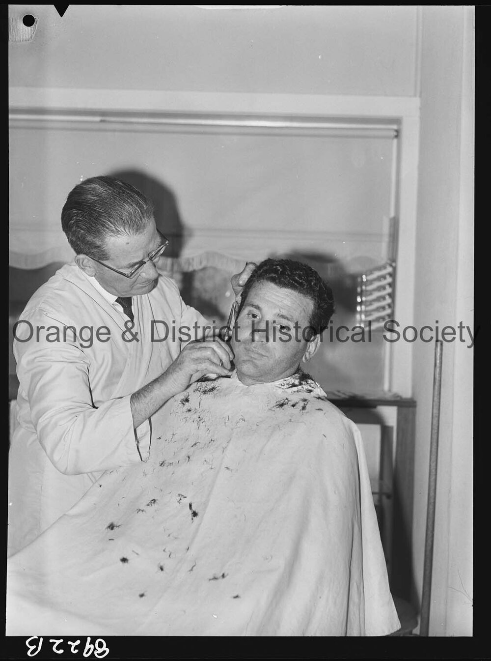 Mr T Stathis has his hair cut by Mr J Baldwin