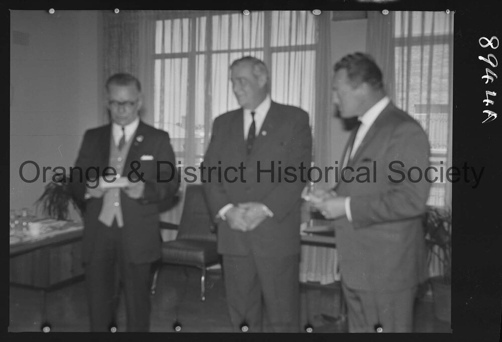 Sir Charles Moses watches while Mr C Spencer hands cheque to Mr F Pritchard