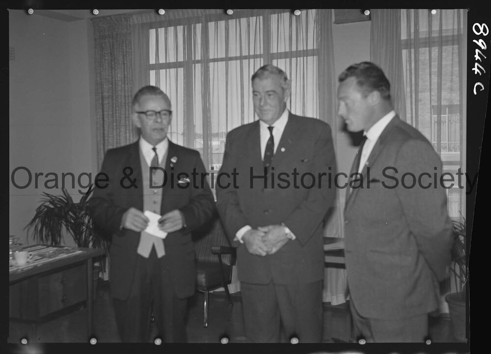 Sir Charles Moses watches while Mr C Spencer hands cheque to Mr F Pritchard
