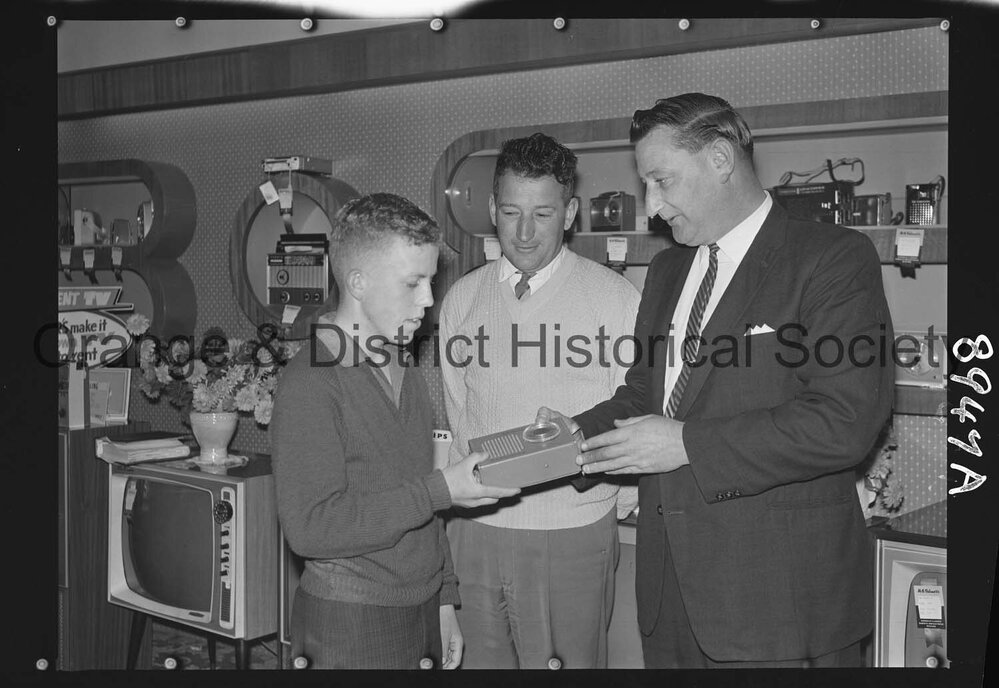 Buena Vista, Ian Oates receives transistor from Mr G Millgate, watched by Mr Bert Gallard