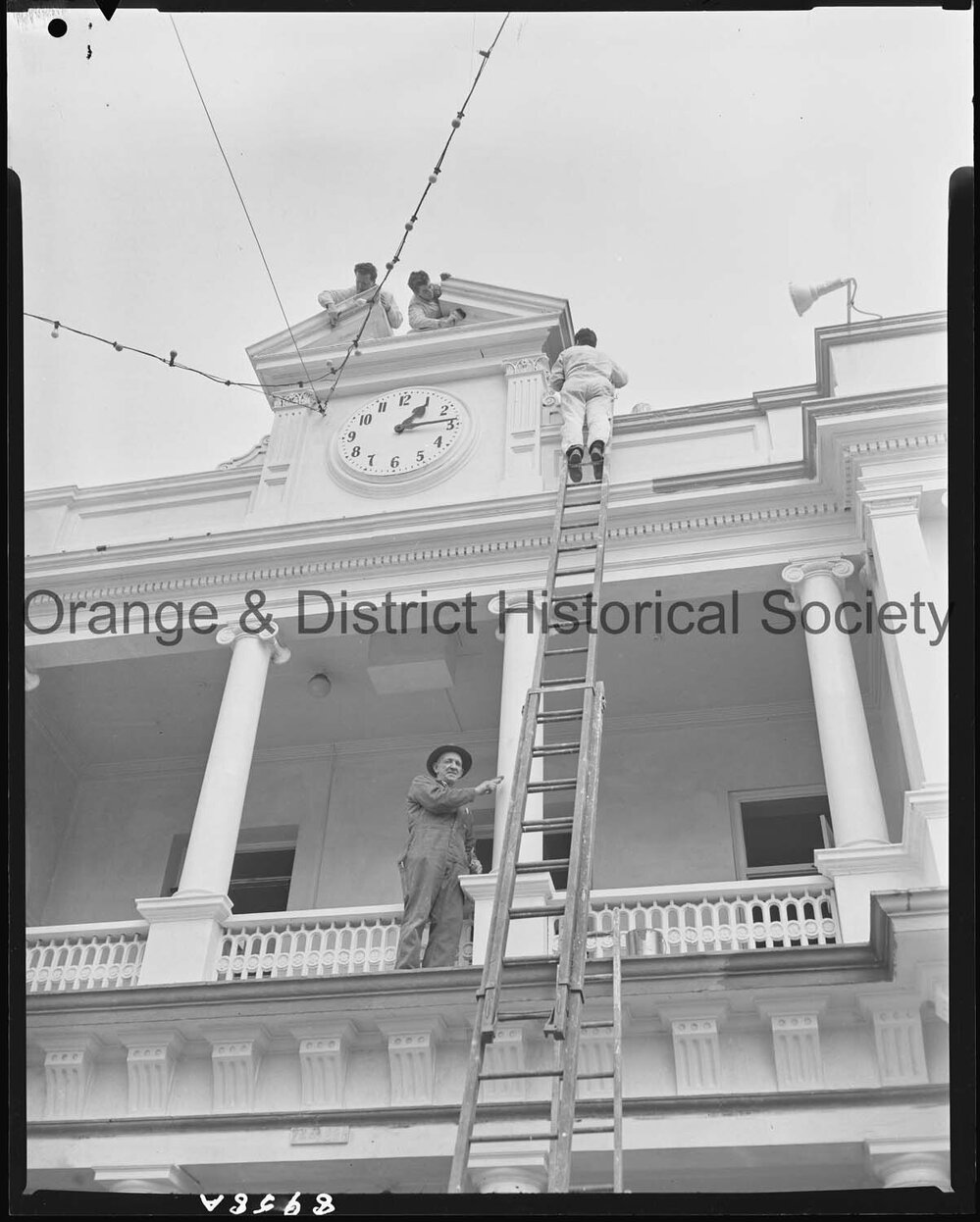 Painting around the Post Office clock