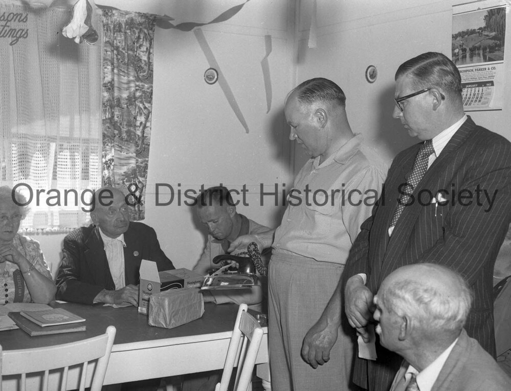 Bill Denman handing present to pensioners