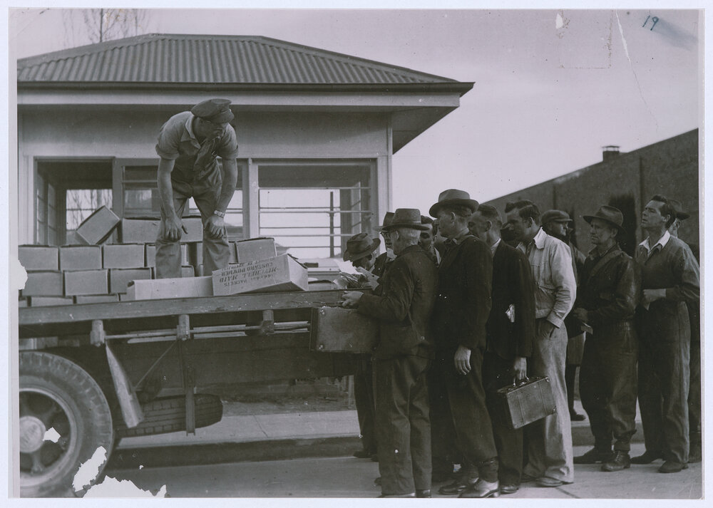 Emmco and Elcon workers queue for food parcels supplied by the company during the devastating national coal strike in 1949
