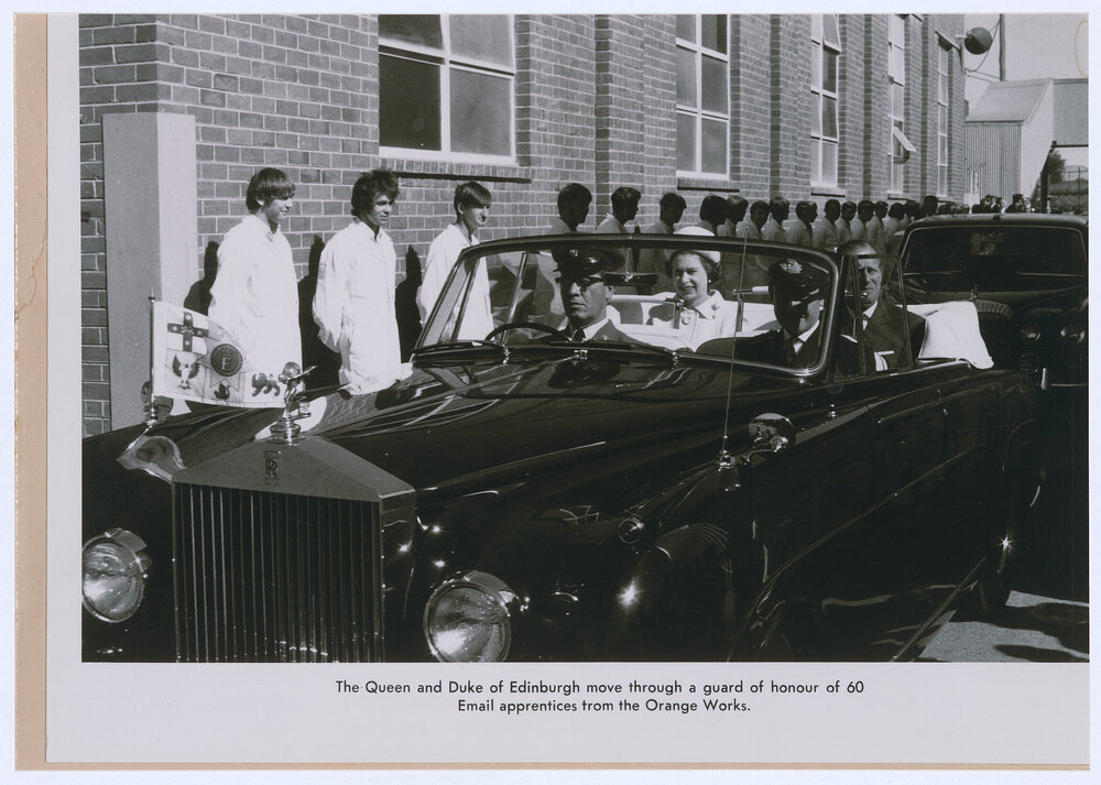 Email apprentices form a guard of honour as Queen Elizabeth and the Duke of Edinburgh leave the plant, Orange