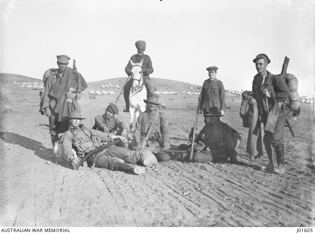 Australian soldiers newly arrived from Gallipoli, escorted by an Indian soldier on horseback, with all their kit, ready to enter rest camp on Lemnos Island