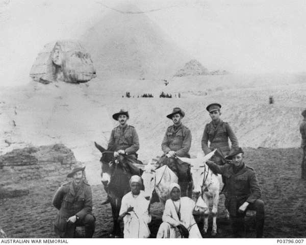 Officers of the 2nd Battalion with two Egyptian guides in front of the Sphinx during a visit to the Pyramids. 2nd Lieutenant Solling is seated on the donkey on the right.