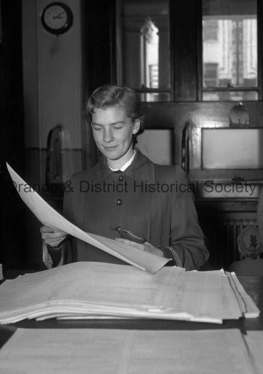 Katherine Langham  picking up tax return sheets