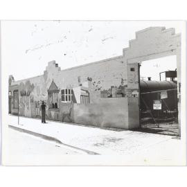 Mural on Gas Works brick wall, person standing in front