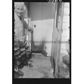 Mrs M Walker shows where vandals broke windows and lit fires at her home