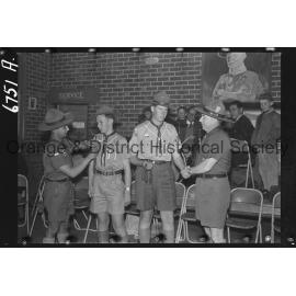 Orange boy scouts awarded with Scout Cords