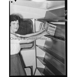 Librarian Joan Barry stacks books in new book mobile