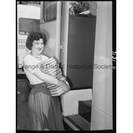 Librarian Joan Barry stacks books in new book mobile