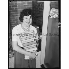 Librarian Joan Barry stacks books in new book mobile