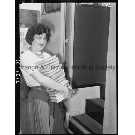 Librarian Joan Barry stacks books in new book mobile