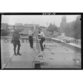 Police erecting the aerial for two-way radio for patrol cars and Police Station