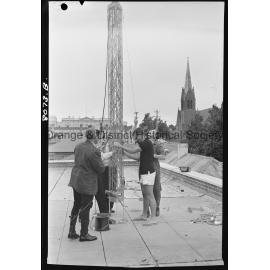 Police erecting the aerial for two-way radio for patrol cars and Police Station