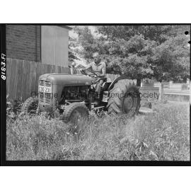 Mr Miller, OCC Works Depot employee cutting long grass in West Orange