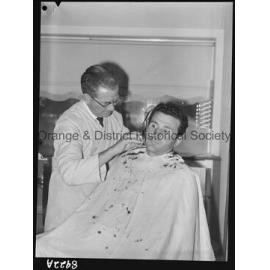 Mr T Stathis has his hair cut by Mr J Baldwin