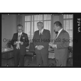 Sir Charles Moses watches while Mr C Spencer hands cheque to Mr F Pritchard
