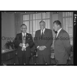 Sir Charles Moses watches while Mr C Spencer hands cheque to Mr F Pritchard