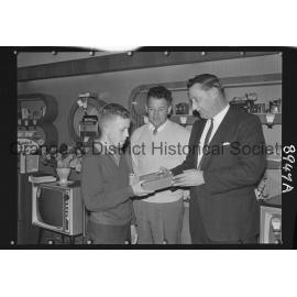 Buena Vista, Ian Oates receives transistor from Mr G Millgate, watched by Mr Bert Gallard