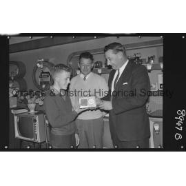 Buena Vista, Ian Oates receives transistor from Mr G Millgate, watched by Mr Bert Gallard