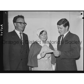 Nurse Rhonda McLean hands over cheque