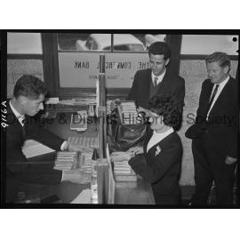 Miss Carol Nonnenmacher banking pennies