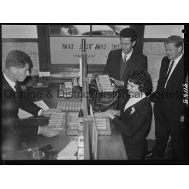 Miss Carol Nonnenmacher banking pennies