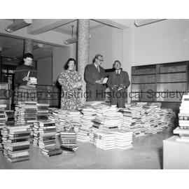 Judy Nicholas and others putting books in Library