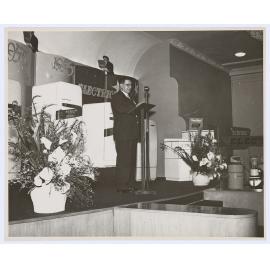 Unidentified man delivering a speech at the Email factory
