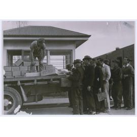 Emmco and Elcon workers queue for food parcels supplied by the company during the devastating national coal strike in 1949