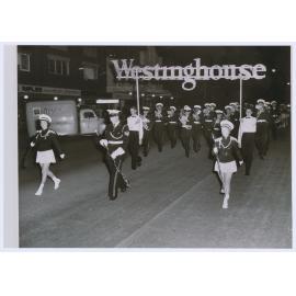 Emmco apprentices Bill Young and Bob Fabry proudly carry the Westinghouse banner along Summer Street, Orange