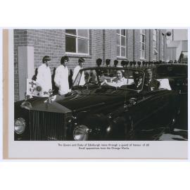 Email apprentices form a guard of honour as Queen Elizabeth and the Duke of Edinburgh leave the plant, Orange