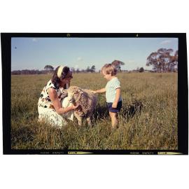 Woman and boy with lamb