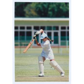 Woman playing cricket