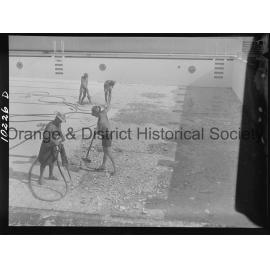 Olympic pool diving board gets a paint over