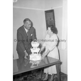 Ald Ridley receiving cake from Mrs D Gregory